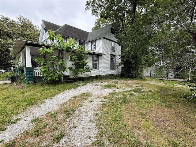 1202 Wall St, Galena, KS 66739 - view of side of property featuring covered porch and a yard