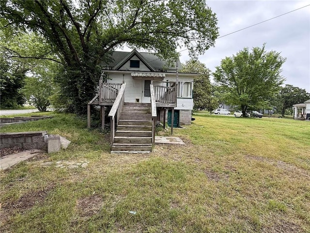 1202 Wall St, Galena, KS 66739 - view of front facade with stairs, a wooden deck, and a front lawn