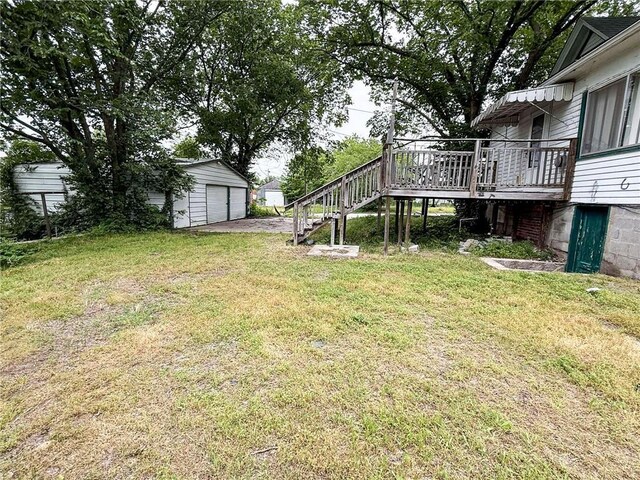 1202 Wall St, Galena, KS 66739 - view of grassy yard with stairs, a garage, an outdoor structure, and a wooden deck
