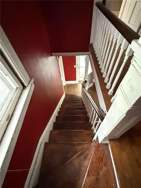 1202 Wall St, Galena, KS 66739 - stairway featuring wood finished floors and baseboards