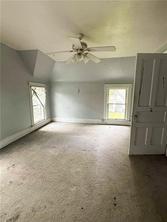 1202 Wall St, Galena, KS 66739 - unfurnished room featuring carpet flooring, baseboards, a ceiling fan, and vaulted ceiling
