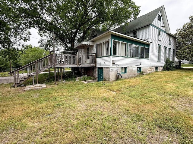 1202 Wall St, Galena, KS 66739 - view of side of home featuring stairs, a deck, a yard, and a sunroom