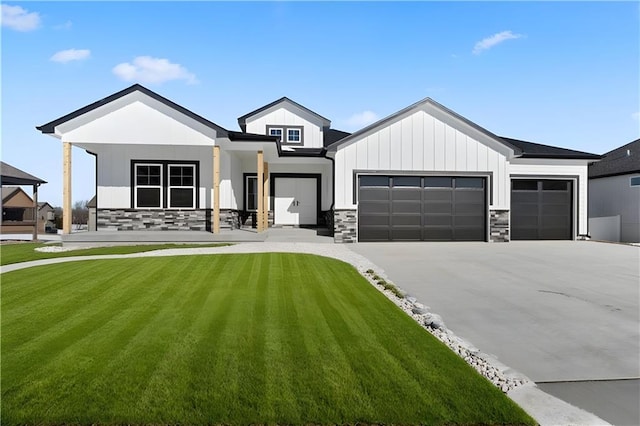 805 W Solomon Dr, Lone Jack, MO 64086 - modern farmhouse featuring an attached garage, stone siding, a front lawn, driveway, and board and batten siding