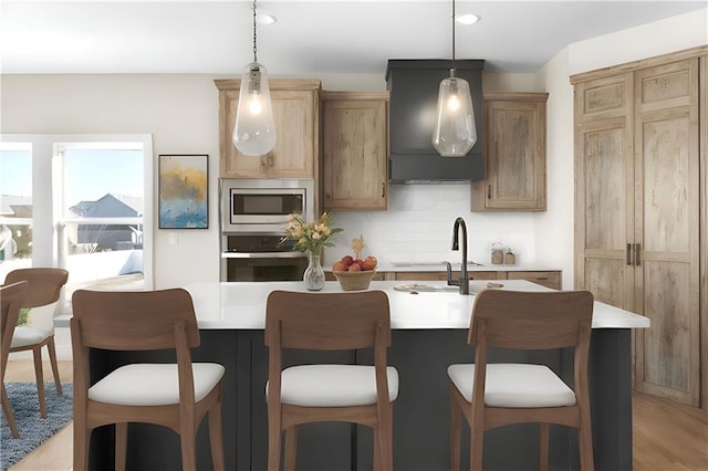 805 W Solomon Dr, Lone Jack, MO 64086 - kitchen featuring appliances with stainless steel finishes, premium range hood, light countertops, a kitchen bar, and recessed lighting