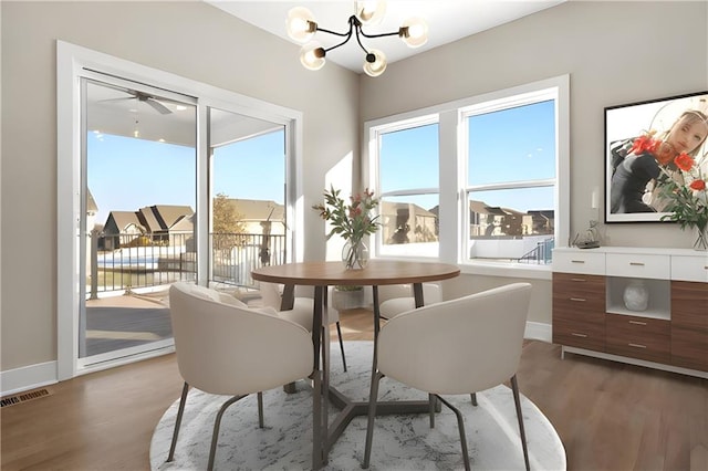 805 W Solomon Dr, Lone Jack, MO 64086 - dining room featuring light wood-style flooring, a chandelier, and baseboards