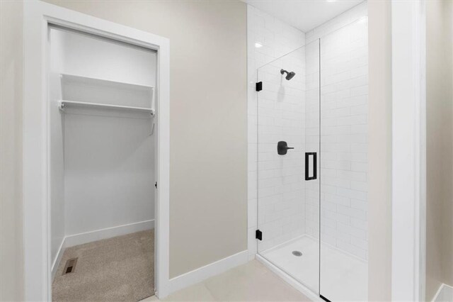 805 W Solomon Dr, Lone Jack, MO 64086 - full bath featuring a stall shower, a spacious closet, and baseboards