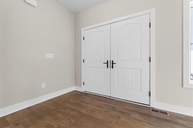 805 W Solomon Dr, Lone Jack, MO 64086 - unfurnished bedroom with wood finished floors, baseboards, and a closet
