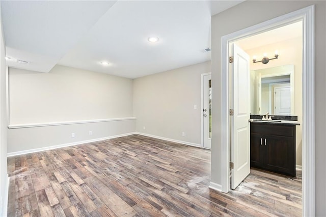 11207 207th St, Peculiar, MO 64078 - unfurnished room with a sink, wood finished floors, baseboards, and recessed lighting