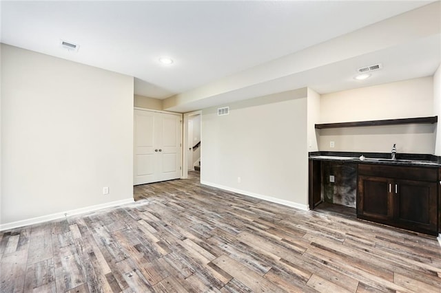 11207 207th St, Peculiar, MO 64078 - unfurnished living room with light wood-style flooring, baseboards, stairway, recessed lighting, and a sink