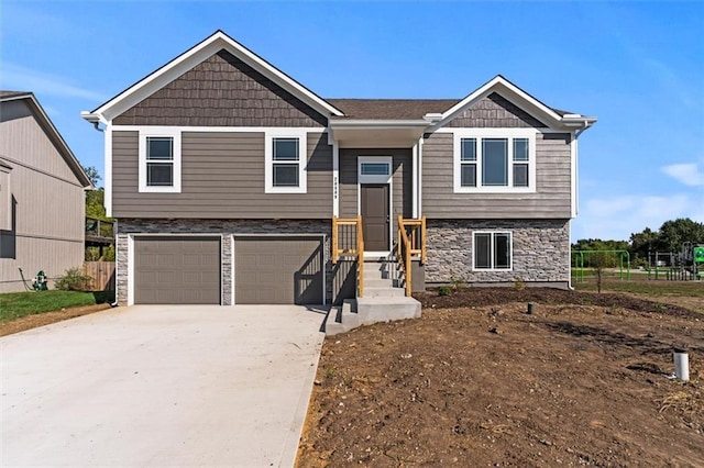 11207 207th St, Peculiar, MO 64078 - bi-level home featuring stone siding, a garage, and concrete driveway