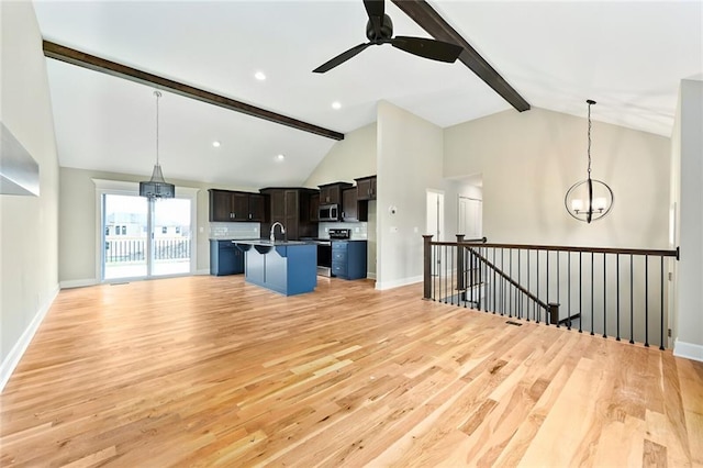 11207 207th St, Peculiar, MO 64078 - unfurnished living room with a chandelier, light wood finished floors, beamed ceiling, a ceiling fan, and baseboards