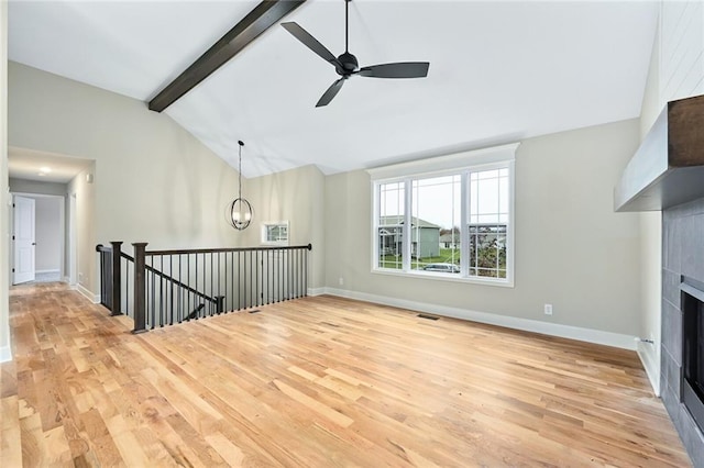 11207 207th St, Peculiar, MO 64078 - unfurnished living room with light wood finished floors, a fireplace, baseboards, and ceiling fan