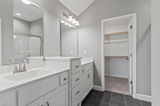 11207 207th St, Peculiar, MO 64078 - full bathroom with vanity, a walk in closet, tile patterned flooring, a shower, and baseboards