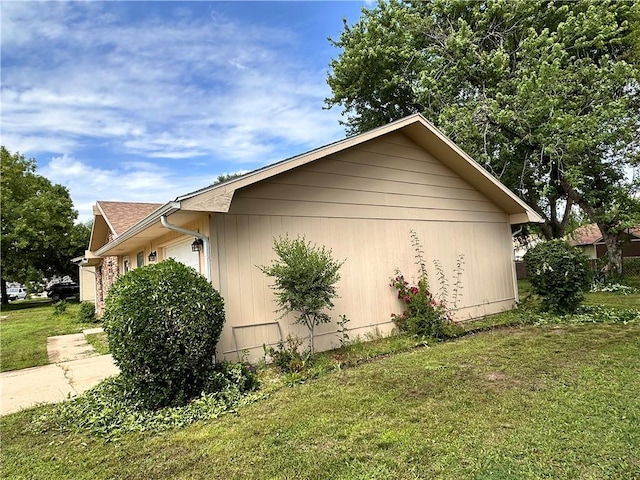 1710 Halsey Ave, Independence, KS 67301 - view of home's exterior with a lawn and an attached garage