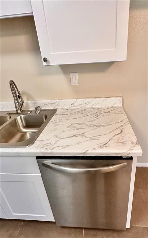 1710 Halsey Ave, Independence, KS 67301 - kitchen view of stainless steel dishwasher, a sink, white cabinets, and light countertops