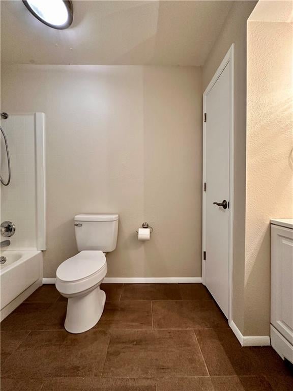 1710 Halsey Ave, Independence, KS 67301 - full bathroom with toilet, bathing tub / shower combination, baseboards, and tile patterned flooring