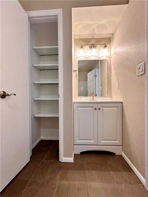 1710 Halsey Ave, Independence, KS 67301 - bathroom featuring vanity, tile patterned flooring, and baseboards