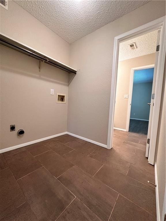 1710 Halsey Ave, Independence, KS 67301 - washroom featuring a textured ceiling, hookup for a washing machine, electric dryer hookup, baseboards, and dark tile patterned floors