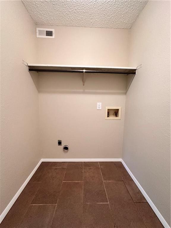1710 Halsey Ave, Independence, KS 67301 - laundry area with washer hookup, hookup for an electric dryer, baseboards, a textured ceiling, and dark tile patterned floors
