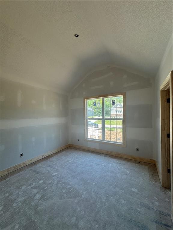 303 SW 17th St, Oak Grove, MO 64029 - spare room with a textured ceiling and vaulted ceiling