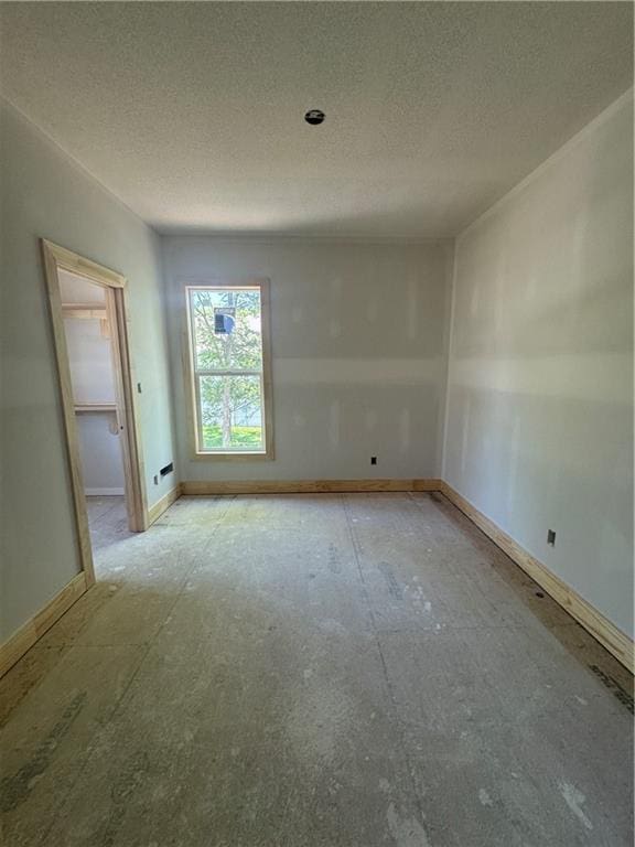 303 SW 17th St, Oak Grove, MO 64029 - empty room featuring a textured ceiling