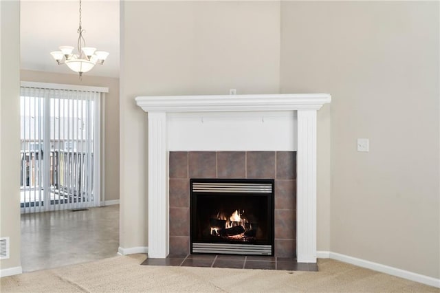 706 E 15th St E, Eudora, KS 66025 - detailed view of a chandelier, baseboards, and a tiled fireplace