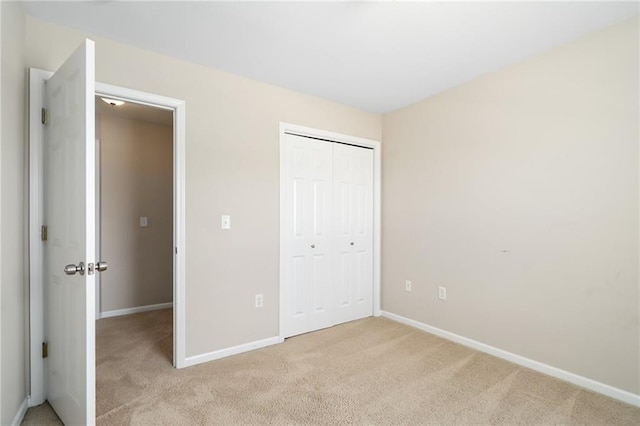 706 E 15th St E, Eudora, KS 66025 - unfurnished bedroom featuring light colored carpet, a closet, and baseboards