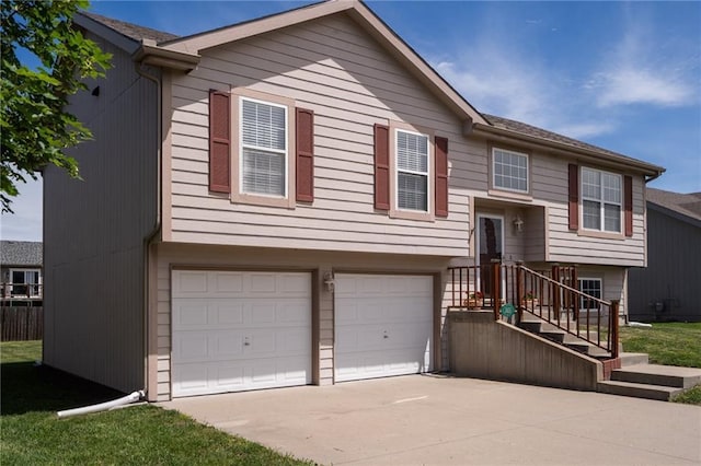 706 E 15th St E, Eudora, KS 66025 - split foyer home featuring a garage and driveway