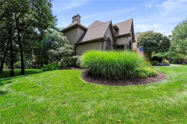 15141 Windsor Cir, Leawood, KS 66224 - view of home's exterior featuring a chimney, stucco siding, and a shingled roof
