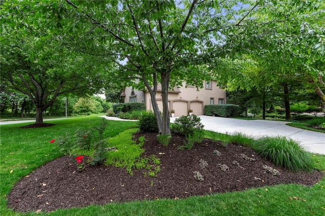 15141 Windsor Cir, Leawood, KS 66224 - view of front facade featuring concrete driveway, a front lawn, stucco siding, and a garage
