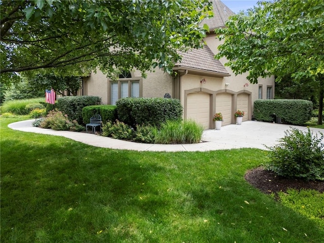 15141 Windsor Cir, Leawood, KS 66224 - view of front of property featuring driveway, stucco siding, a front lawn, and an attached garage