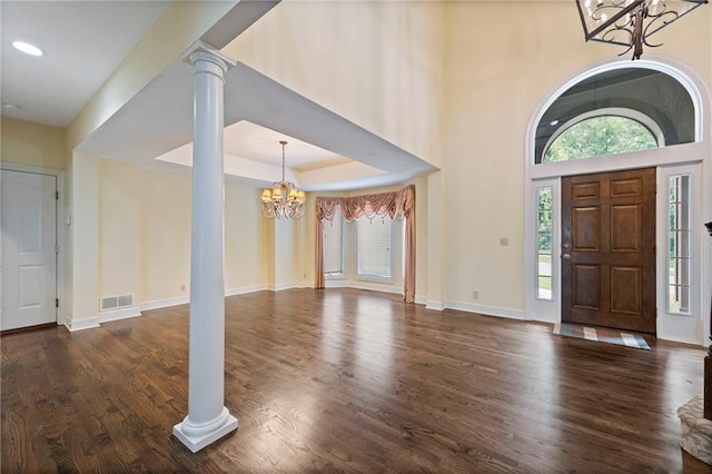 15141 Windsor Cir, Leawood, KS 66224 - foyer featuring a chandelier, dark wood-style floors, decorative columns, and recessed lighting