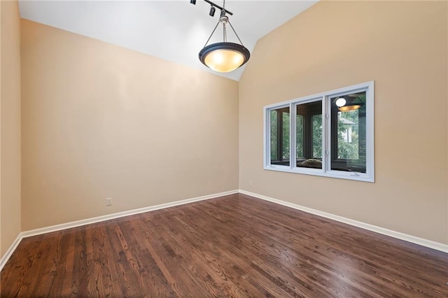 15141 Windsor Cir, Leawood, KS 66224 - spare room with dark wood finished floors, high vaulted ceiling, and track lighting