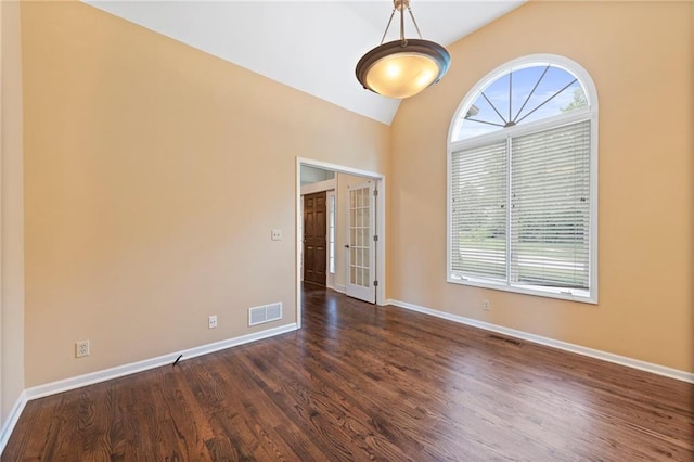15141 Windsor Cir, Leawood, KS 66224 - spare room with dark wood-type flooring, vaulted ceiling, and french doors