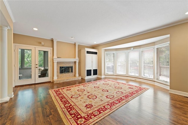 15141 Windsor Cir, Leawood, KS 66224 - living area featuring ornamental molding, decorative columns, wood finished floors, french doors, and a high end fireplace