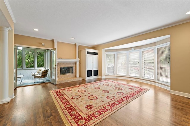 15141 Windsor Cir, Leawood, KS 66224 - living room featuring ornate columns, ornamental molding, a premium fireplace, wood finished floors, and recessed lighting