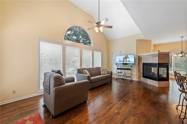 15141 Windsor Cir, Leawood, KS 66224 - living area featuring high vaulted ceiling, plenty of natural light, a ceiling fan, wood finished floors, and a tile fireplace