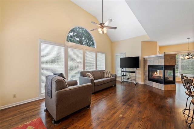 15141 Windsor Cir, Leawood, KS 66224 - living room featuring high vaulted ceiling, healthy amount of natural light, ceiling fan, dark wood-style flooring, and a tile fireplace