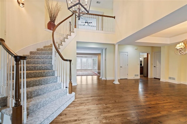 15141 Windsor Cir, Leawood, KS 66224 - entrance foyer featuring a chandelier, wood finished floors, stairway, and a high ceiling