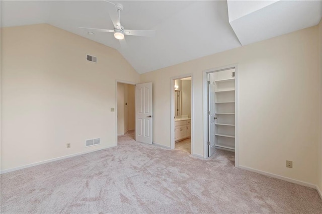 15141 Windsor Cir, Leawood, KS 66224 - unfurnished bedroom featuring vaulted ceiling, light colored carpet, a walk in closet, ensuite bath, and ceiling fan