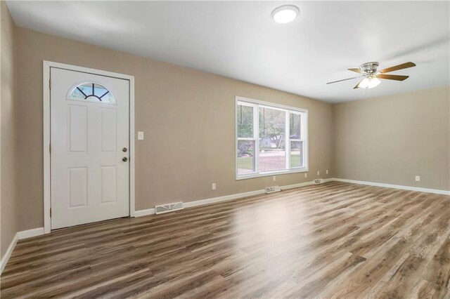 707 N Delaware St, Butler, MO 64730 - foyer featuring wood finished floors, baseboards, and ceiling fan
