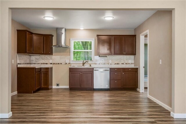 707 N Delaware St, Butler, MO 64730 - kitchen with wall chimney range hood, dishwasher, dark wood-type flooring, a sink, and tasteful backsplash