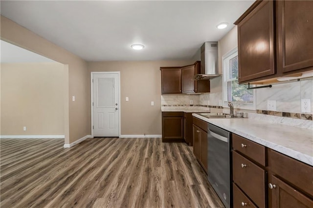 707 N Delaware St, Butler, MO 64730 - kitchen featuring wall chimney range hood, dishwasher, a sink, wood finished floors, and baseboards