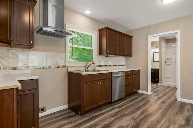 707 N Delaware St, Butler, MO 64730 - kitchen featuring wall chimney exhaust hood, stainless steel dishwasher, a sink, light countertops, and dark wood-style floors