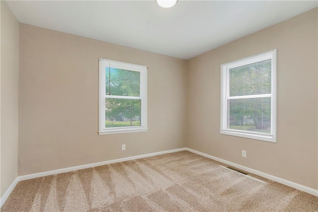 707 N Delaware St, Butler, MO 64730 - carpeted empty room featuring baseboards