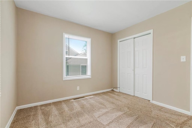 707 N Delaware St, Butler, MO 64730 - unfurnished bedroom with carpet floors, baseboards, and a closet