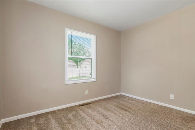 707 N Delaware St, Butler, MO 64730 - empty room featuring carpet and baseboards