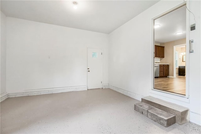 707 N Delaware St, Butler, MO 64730 - spare room featuring speckled floor