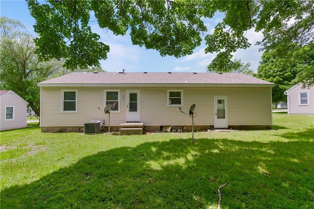 707 N Delaware St, Butler, MO 64730 - back of property featuring a yard and central AC unit