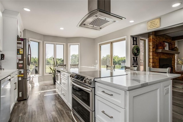 24208 E Orient Cemetery Rd, Harrisonville, MO 64701 - kitchen featuring stainless steel appliances, island exhaust hood, dark wood-style flooring, recessed lighting, and white cabinets